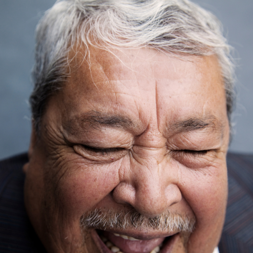 A elderly man smiles