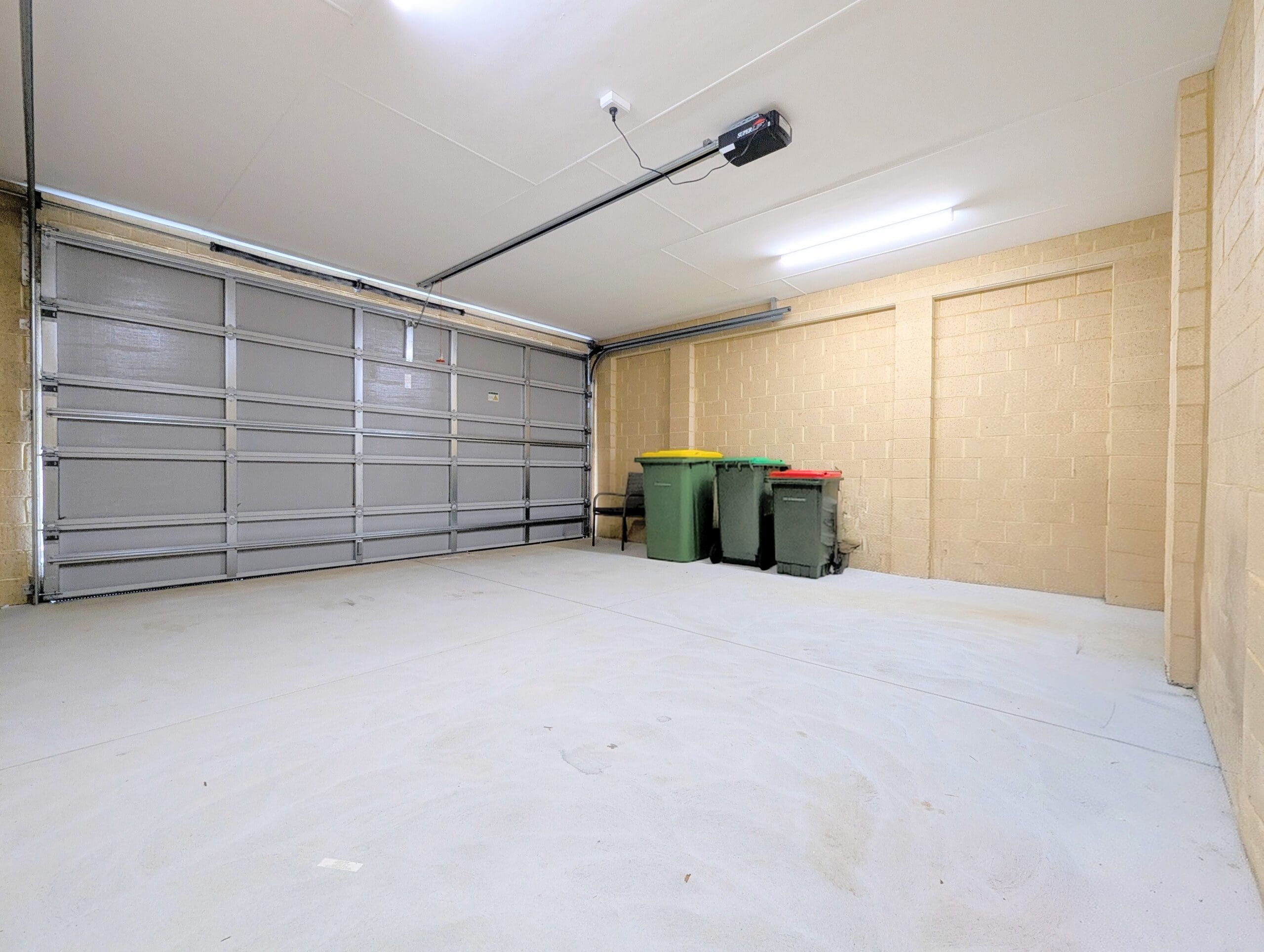 Spacious, accessible garage in an SDA Property in Baldivis, featuring automated roller door and ample storage space part of Australia’s leading disability accommodation provider.