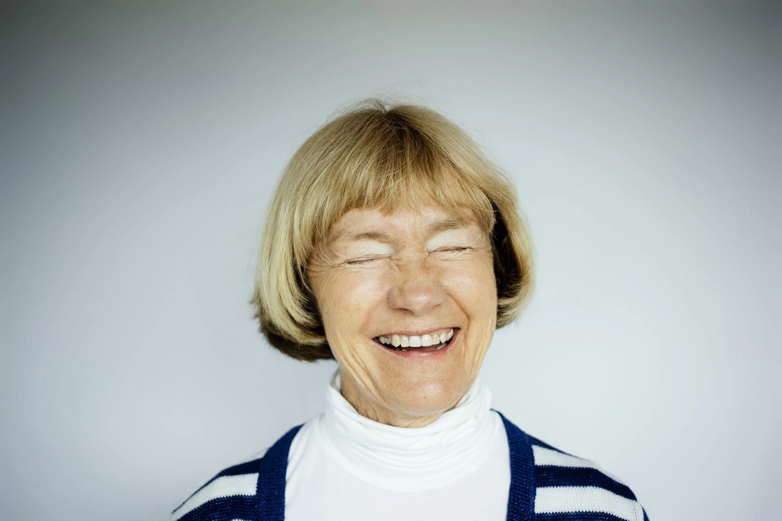 Portrait of happy senior woman on white background