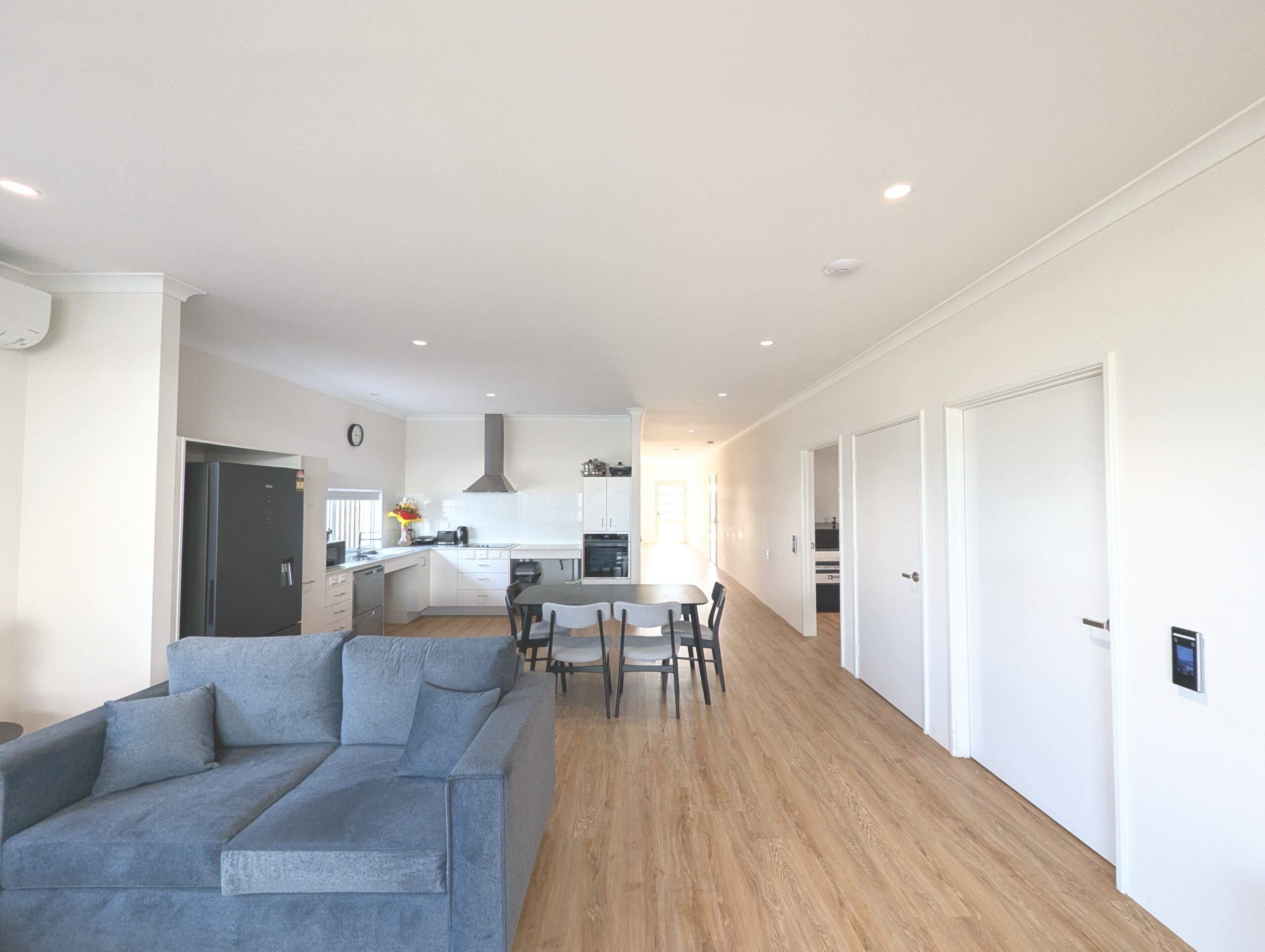Spacious open-plan living area in an SDA Property in Baldivis, featuring lounge, dining, and modern kitchen, part of Australia’s leading disability accommodation provider.