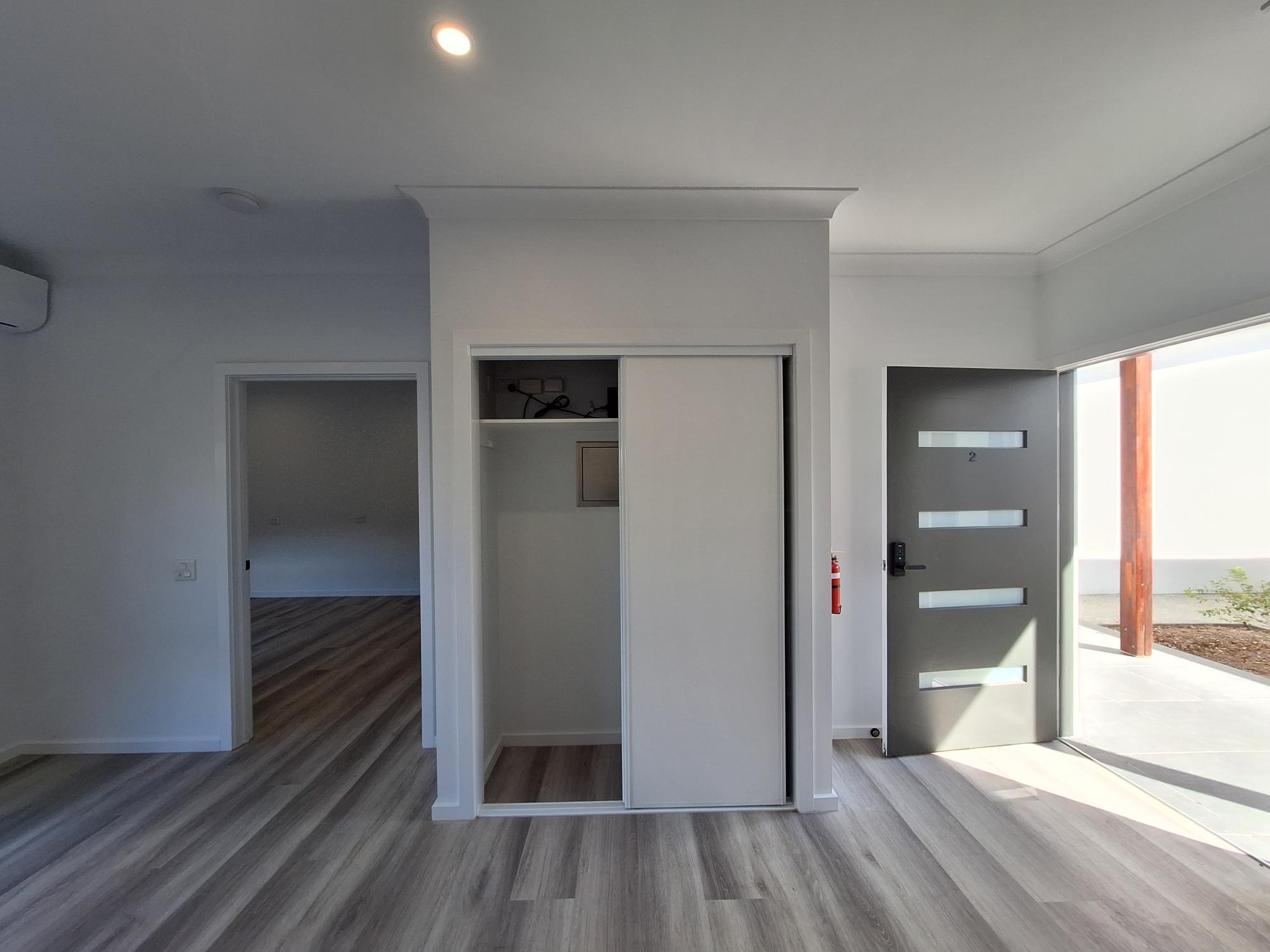 Accessible hallway in a SIL in Brand New HPS Villas in Brassall, 14 Hayes St, Brassall Qld 4305, featuring light wood flooring, wide doorways, and safety features, part of Australia’s leading disability accommodation provider.