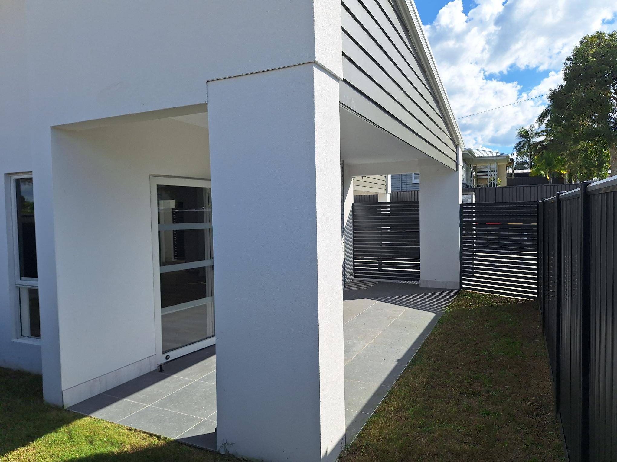 Modern, accessible entrance to a SIL in Brand New HPS Villas in Brassall, 14 Hayes St, Brassall Qld 4305, featuring covered walkway, wide path, and contemporary design, part of Australia’s leading disability accommodation provider.