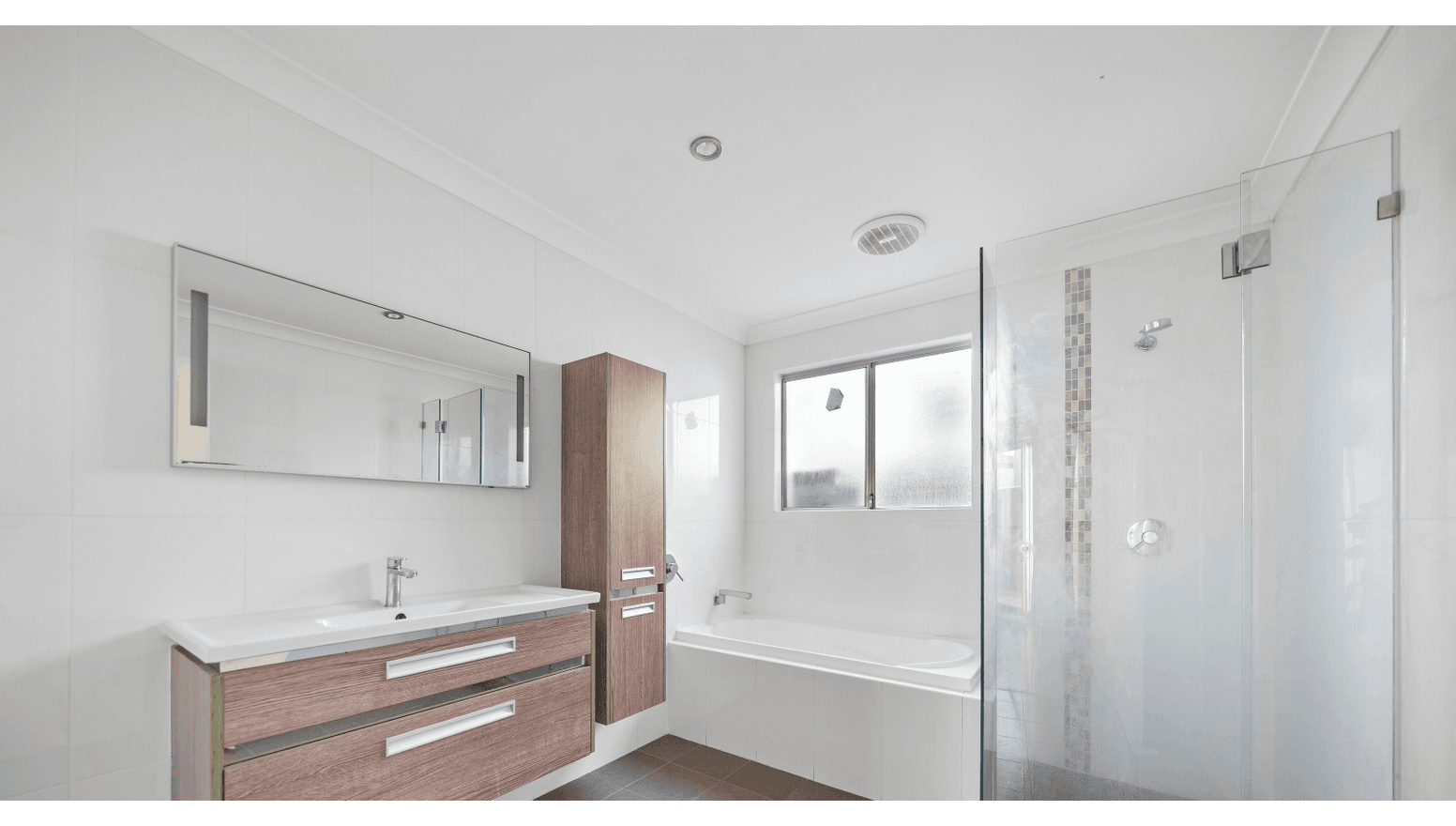 Modern, accessible second bathroom in a Supported Independent Living (SIL) Home in Morley, Australia, featuring walk-in shower, bath, and wood-finish vanity, part of Australia’s leading disability accommodation provider.