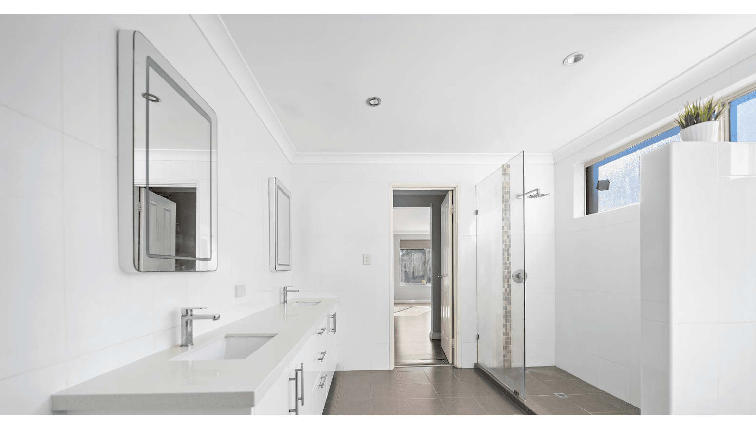 Spacious, accessible bathroom in a Supported Independent Living (SIL) Home in Morley, Australia, featuring dual sinks, walk-in shower, and ample natural light, part of Australia’s leading disability accommodation provider.