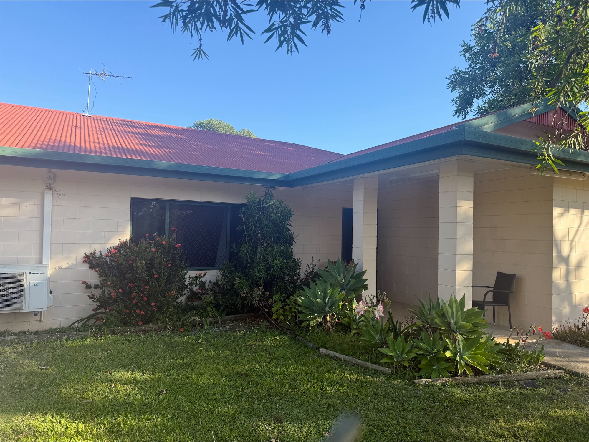 Welcoming exterior of a Central and Roomy SIL home in Mareeba, 6 Kylie Close, Mareeba 4880, featuring covered porch, lush garden, and classic design, part of Australia’s leading disability accommodation provider.