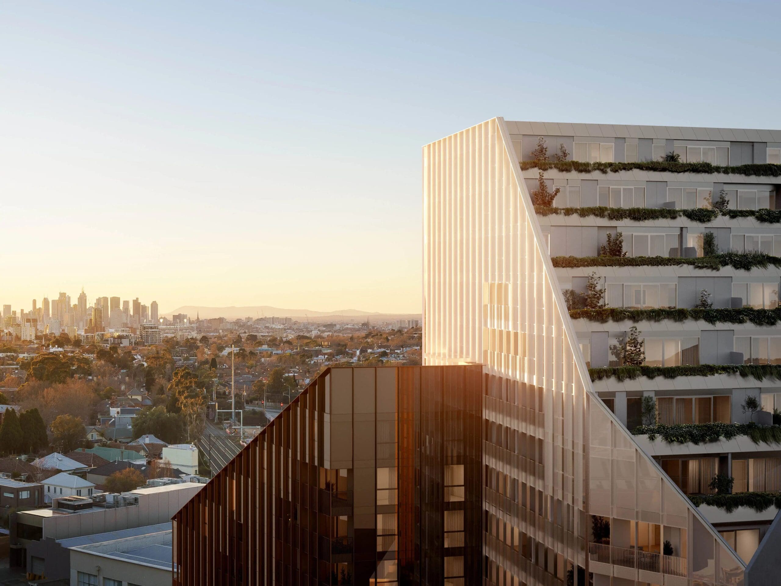 Modern high-rise exterior of Multiple SDA apartments in Malvern with SIL supports, featuring green terraces and city views, part of Australia’s leading disability accommodation provider.